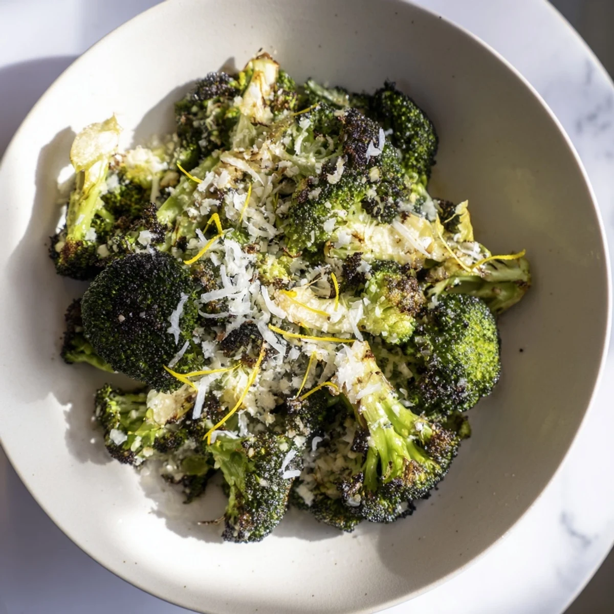 Crispy Simple Garlic and Parmesan Roasted Broccoli speckled with golden, melted Parmesan cheese, ready to serve.