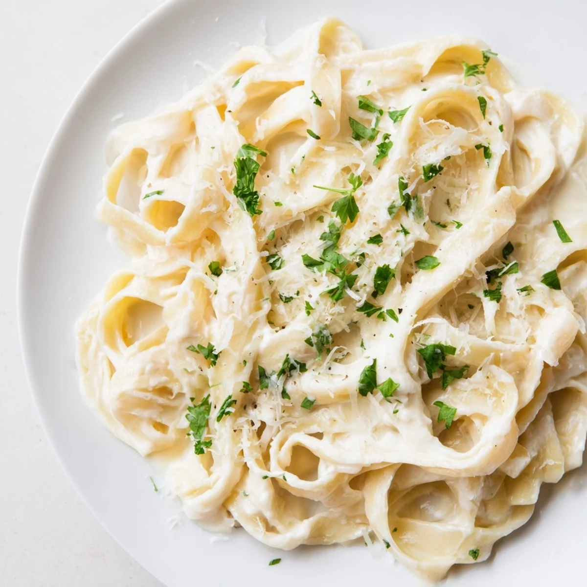 A close-up of pasta coated in flavorful sauce. This Pasta Alfredo Cottage Hack looks delicious and comforting.