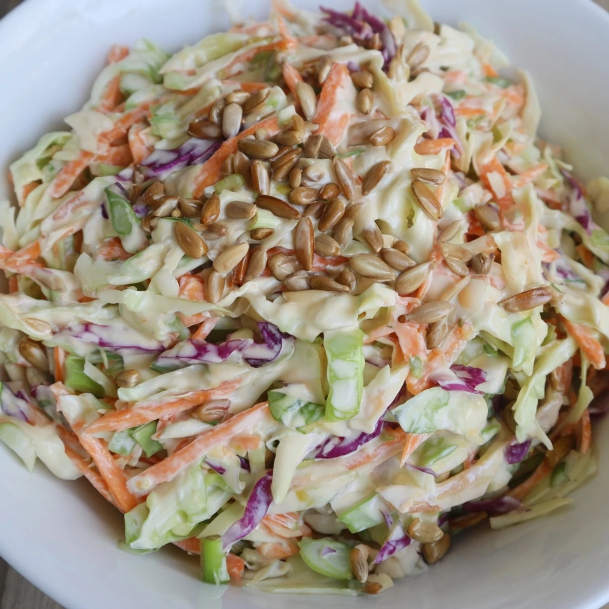 Photo of delicious crunchy coleslaw salad, a colorful vegetarian side dish, prepped and ready.