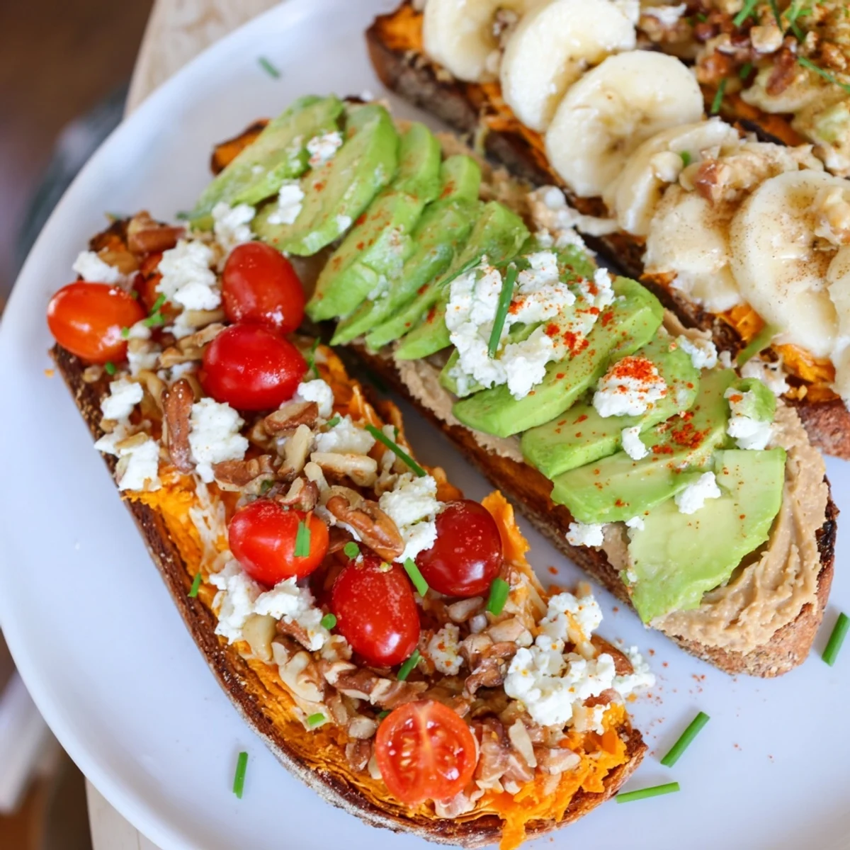Warm sweet potato toasts spread with creamy peanut butter, sliced banana, and crunchy granola.  