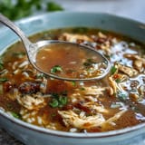 A steaming bowl of Easy Chicken and Rice Soup with tender chicken, hearty rice, and fresh vegetables in savory broth.