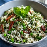Vibrant Spring Pea and Mint Rice Pilaf with fresh peas and aromatic herbs, a light vegetarian side dish.