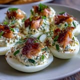Deviled eggs elevated with smoked salmon, zesty lemon, and a sprinkle of everything bagel seasoning for a savory bite.