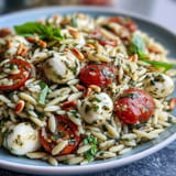 This easy Cold Pesto Orzo Salad looks refreshing, perfect for summer picnics.