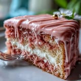 Rich rosé velvet cake with luscious cream cheese frosting and shimmering gold.