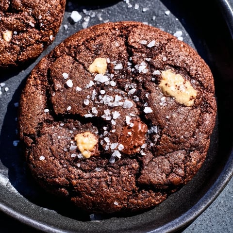 Gooey Warm Chocolate Chunk Skillet Cookie, served warm with vanilla ice cream and flaky sea salt.