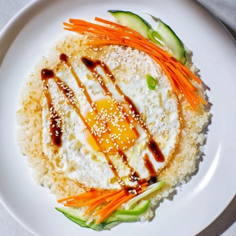 Golden, crispy base of the Egg Rice Bowl with a runny egg yolk and vibrant toppings.