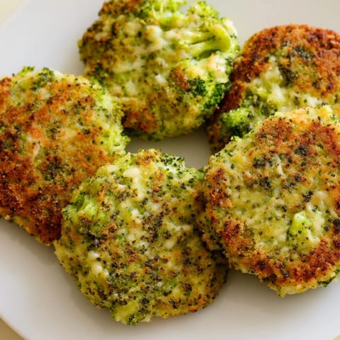A close-up of delicious Cheesy Broccoli Patties, showcasing the melted cheese and crunchy exterior, perfect for a snack.