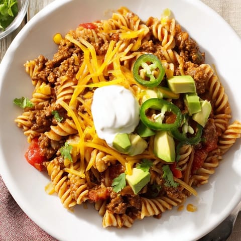 This satisfying Beef Taco Pasta Skillet shows tender pasta and seasoned ground beef; ready to eat.