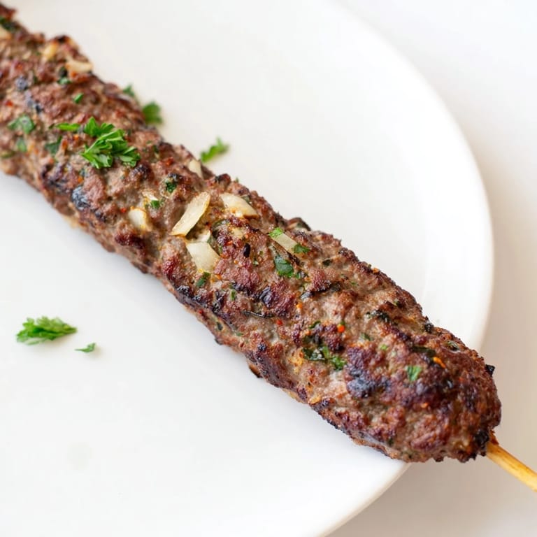 Delicious, spiced Iraqi Kebab Tikka, cooked until charred and juicy, served with flatbread and vibrant toppings.